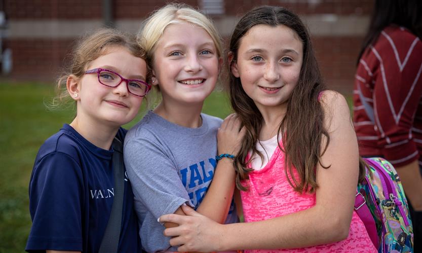 Three girls smile
